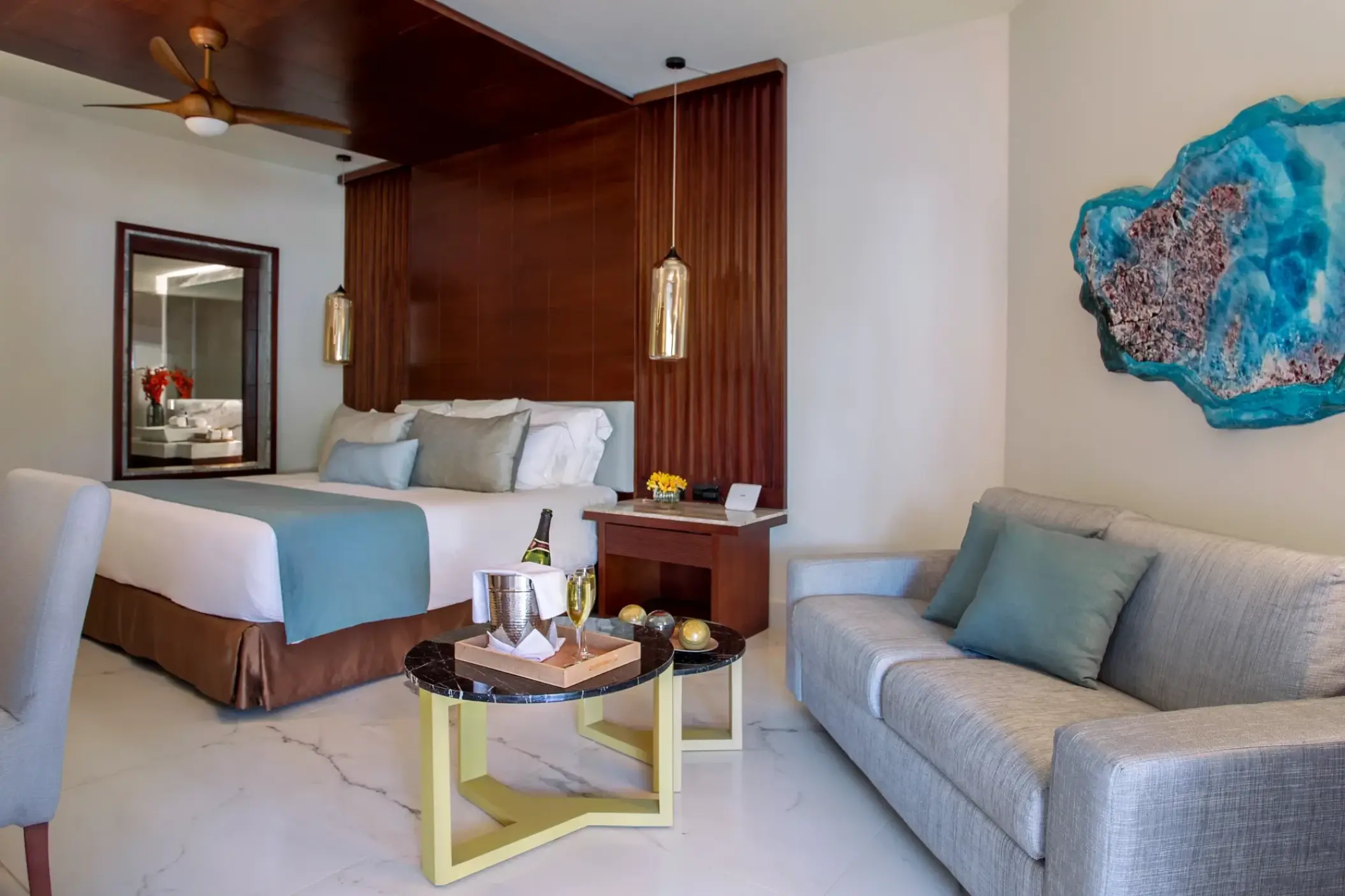 Junior Suite king guest room with sitting area and dark wood accents at Secrets Royal Beach, Punta Cana