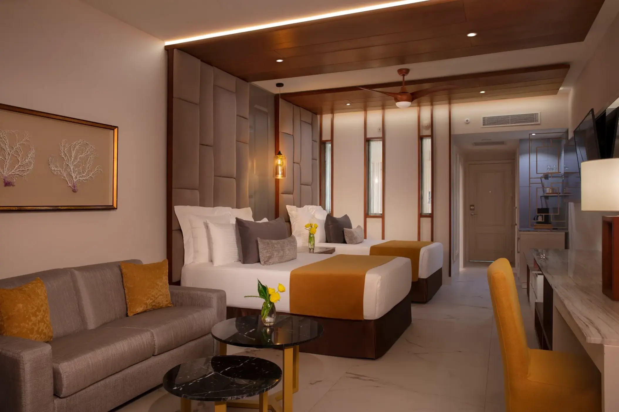 Junior suite with two double beds and a seating area at Secrets Royal Beach, Punta Cana