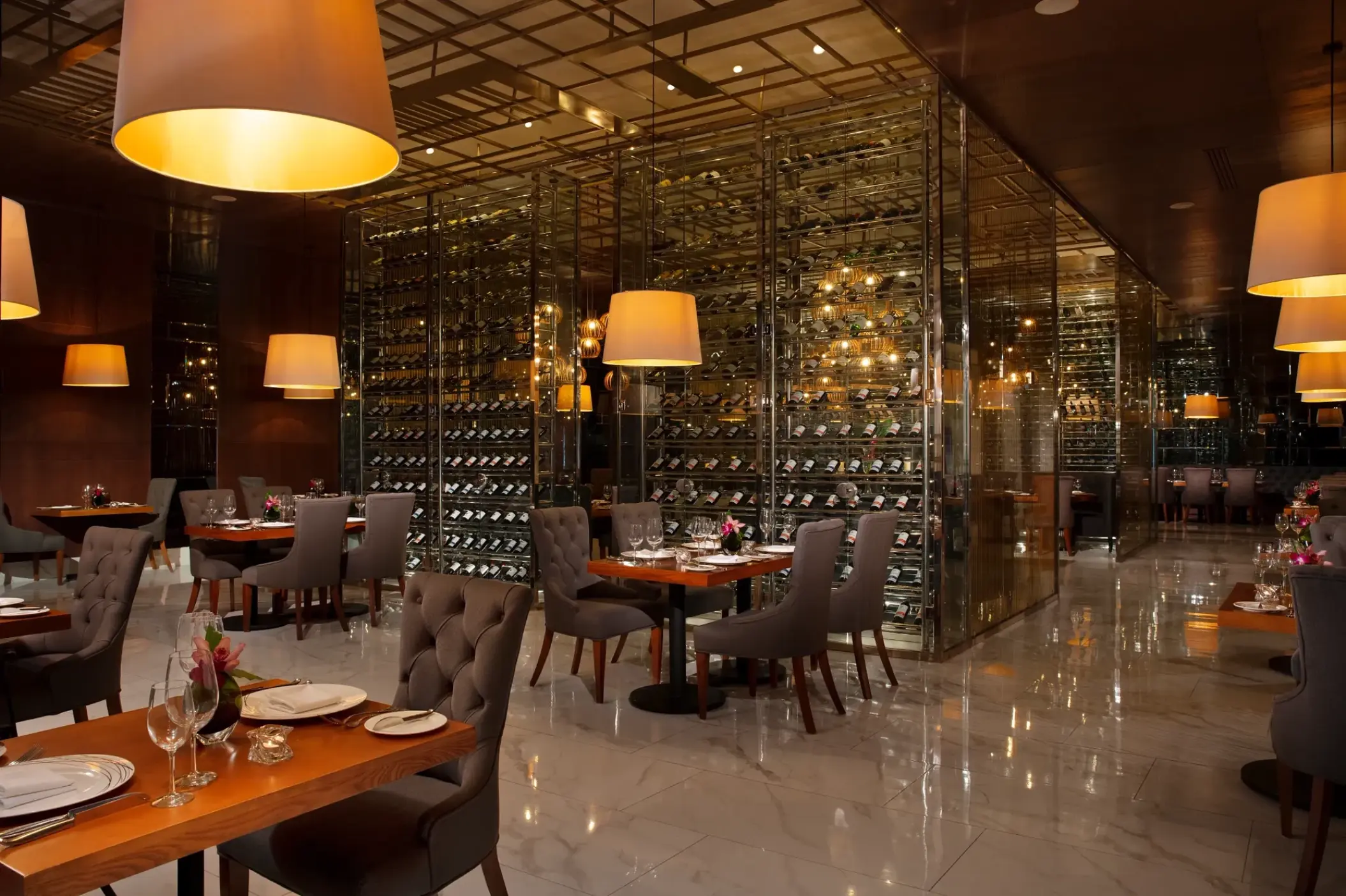 Bordeaux restaurant interior with glass wine cellar at Secrets Royal Beach, Punta Cana