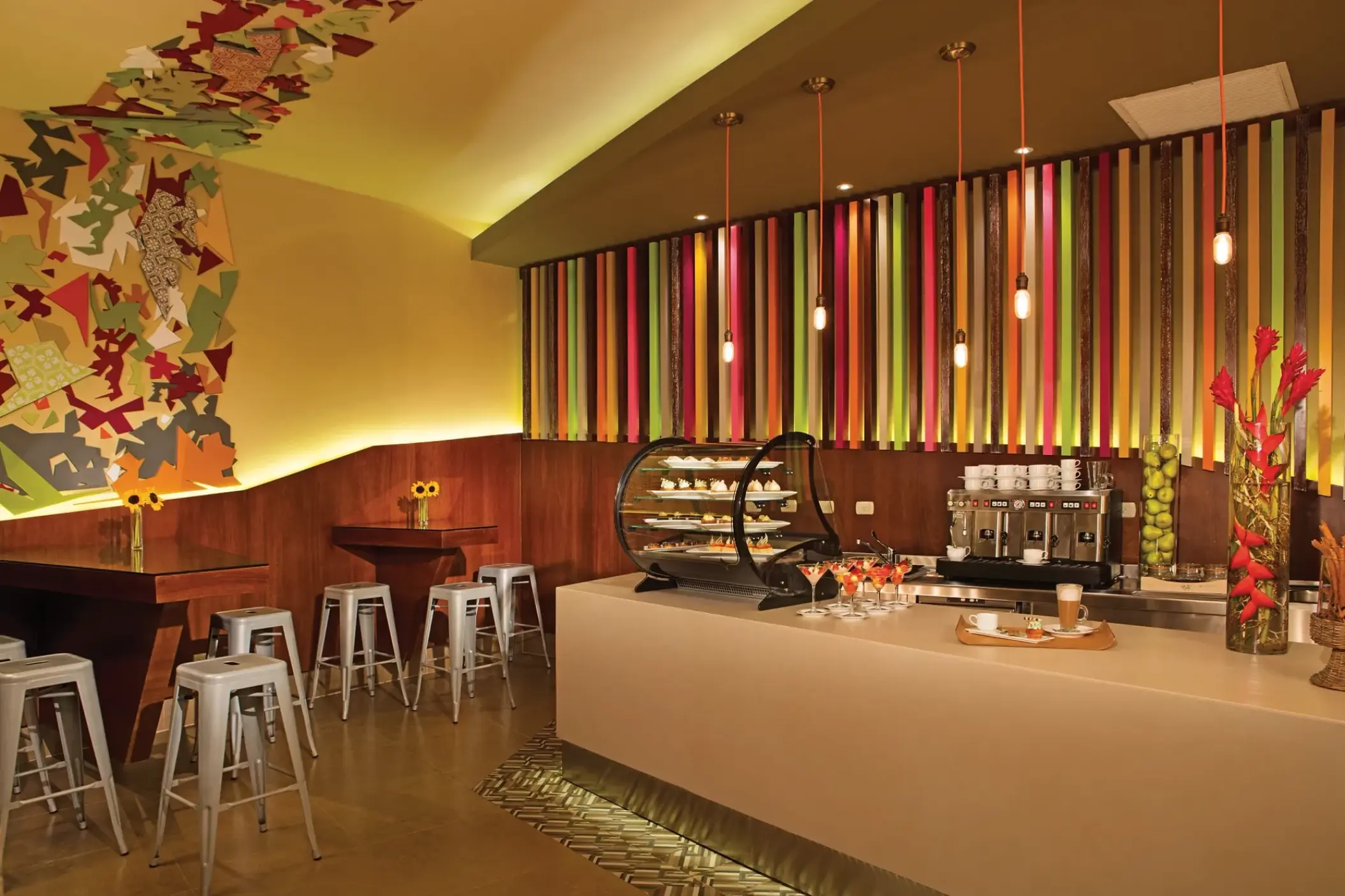 Coco Café with colorful wall art and pastry display at Secrets Royal Beach, Punta Cana