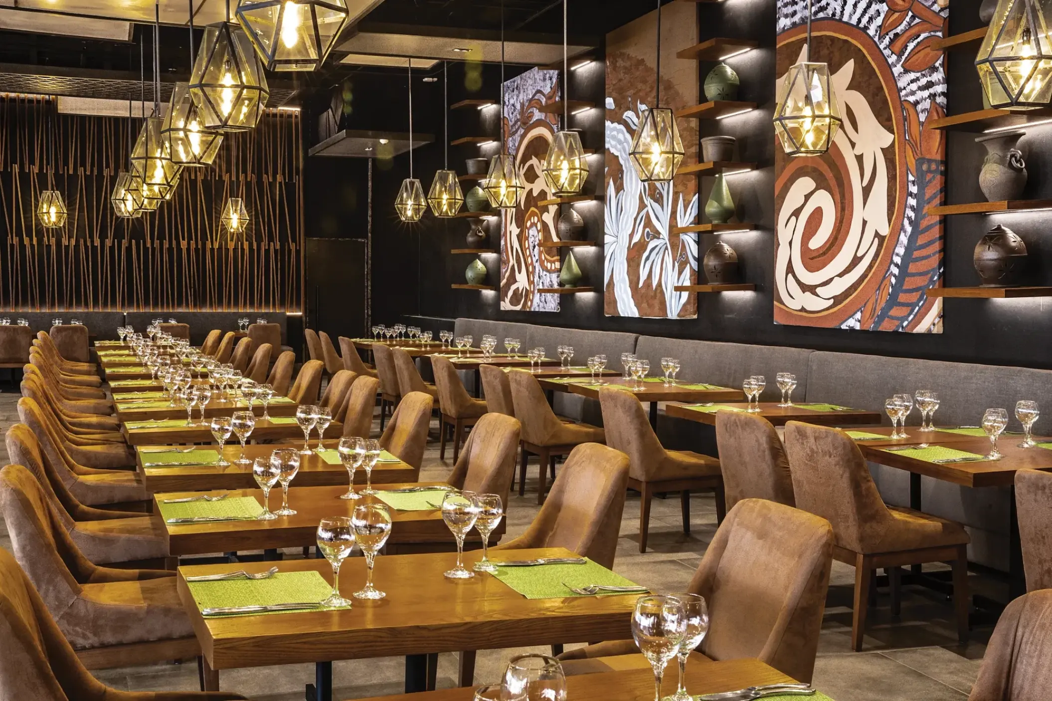 El Patio restaurant dining room with geometric pendant lights at Secrets Royal Beach, Punta Cana