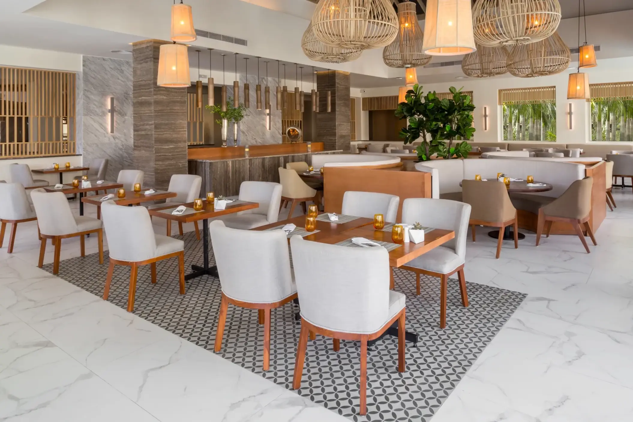 Modern dining room with wicker pendant lights at Secrets Royal Beach, Punta Cana
