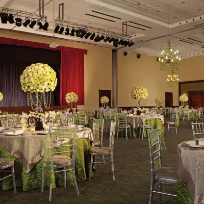Indoor wedding reception with green and silver decor at Secrets Royal Beach, Punta Cana