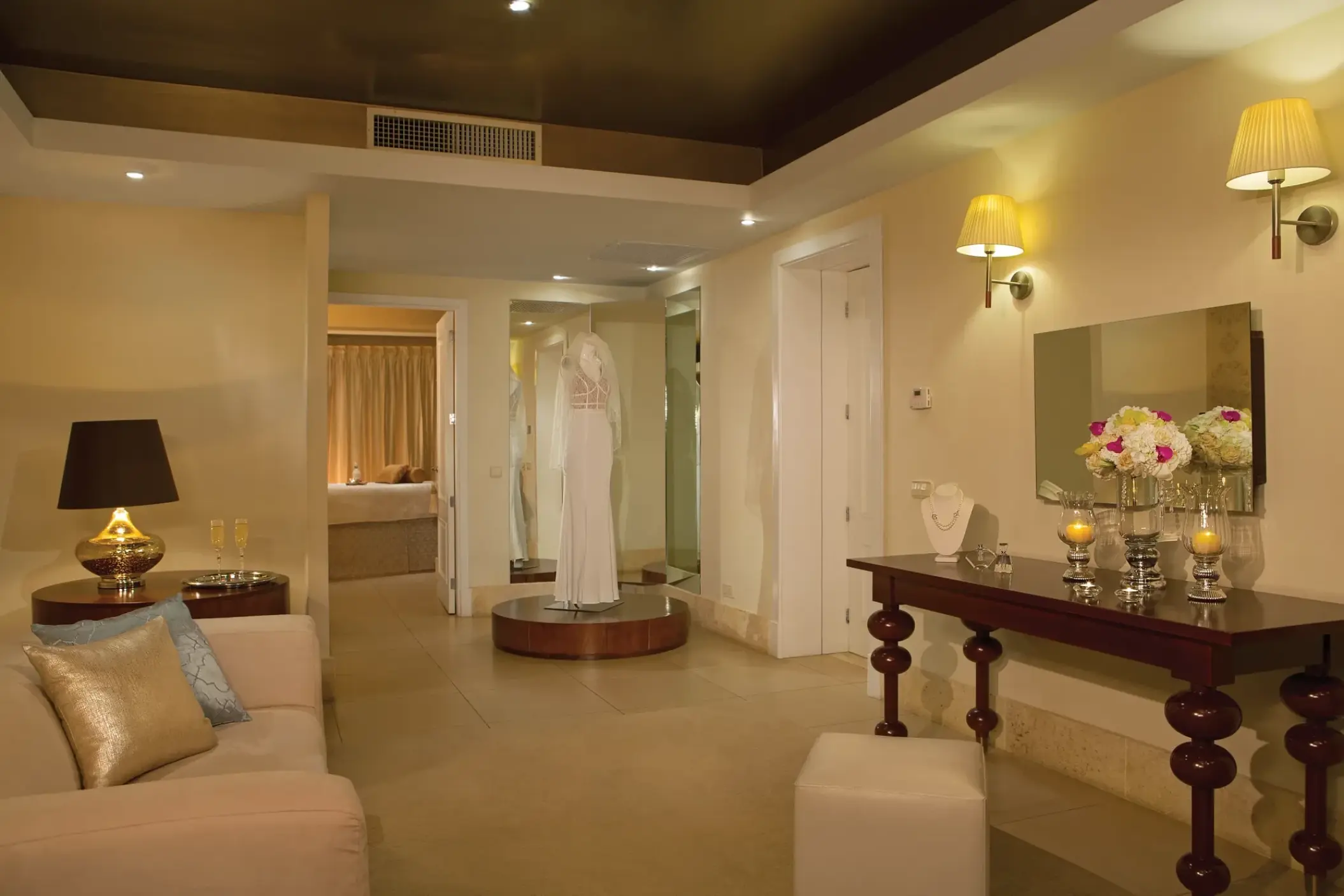 Bridal suite with white wedding dress and vanity at Secrets Royal Beach, Punta Cana