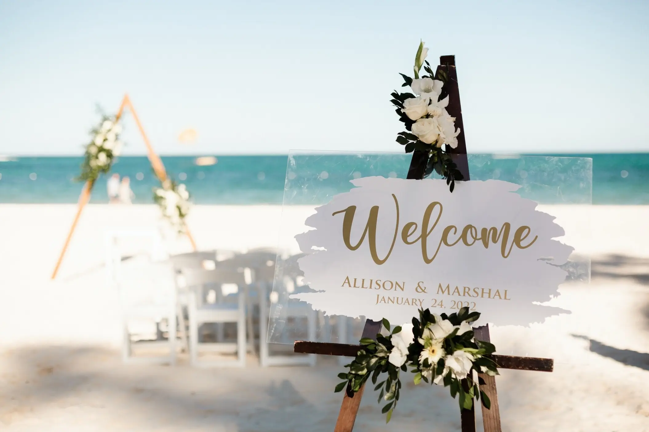 Acrylic welcome sign at a beachfront wedding ceremony in Secrets Royal Beach, Punta Cana