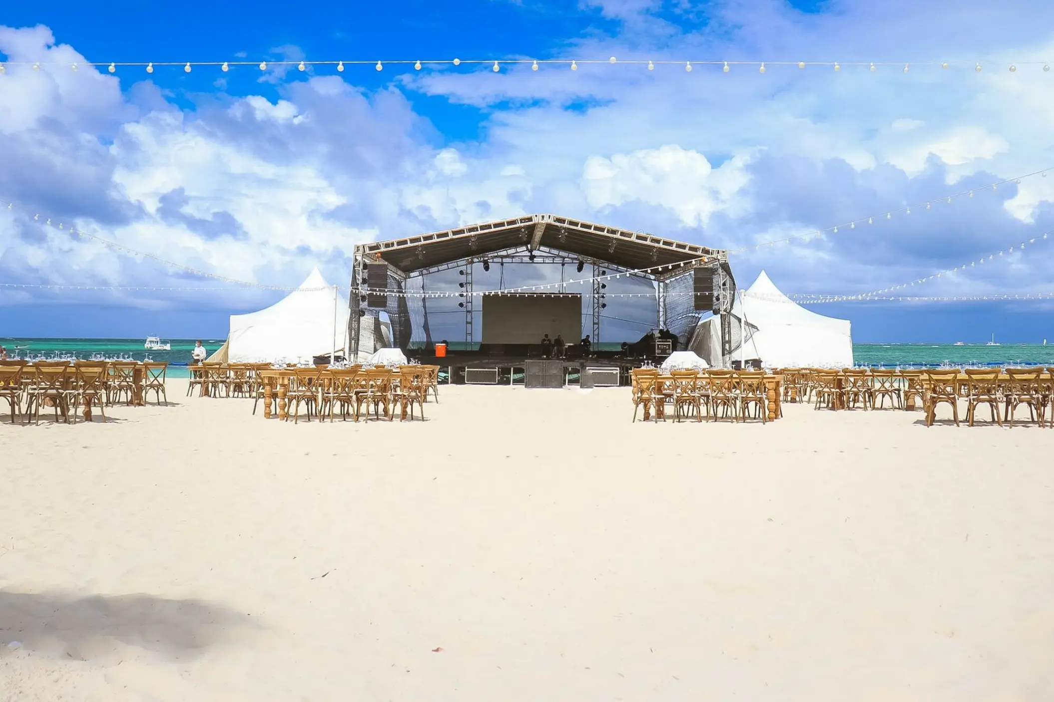 Beachfront wedding reception stage and seating at Secrets Royal Beach, Punta Cana