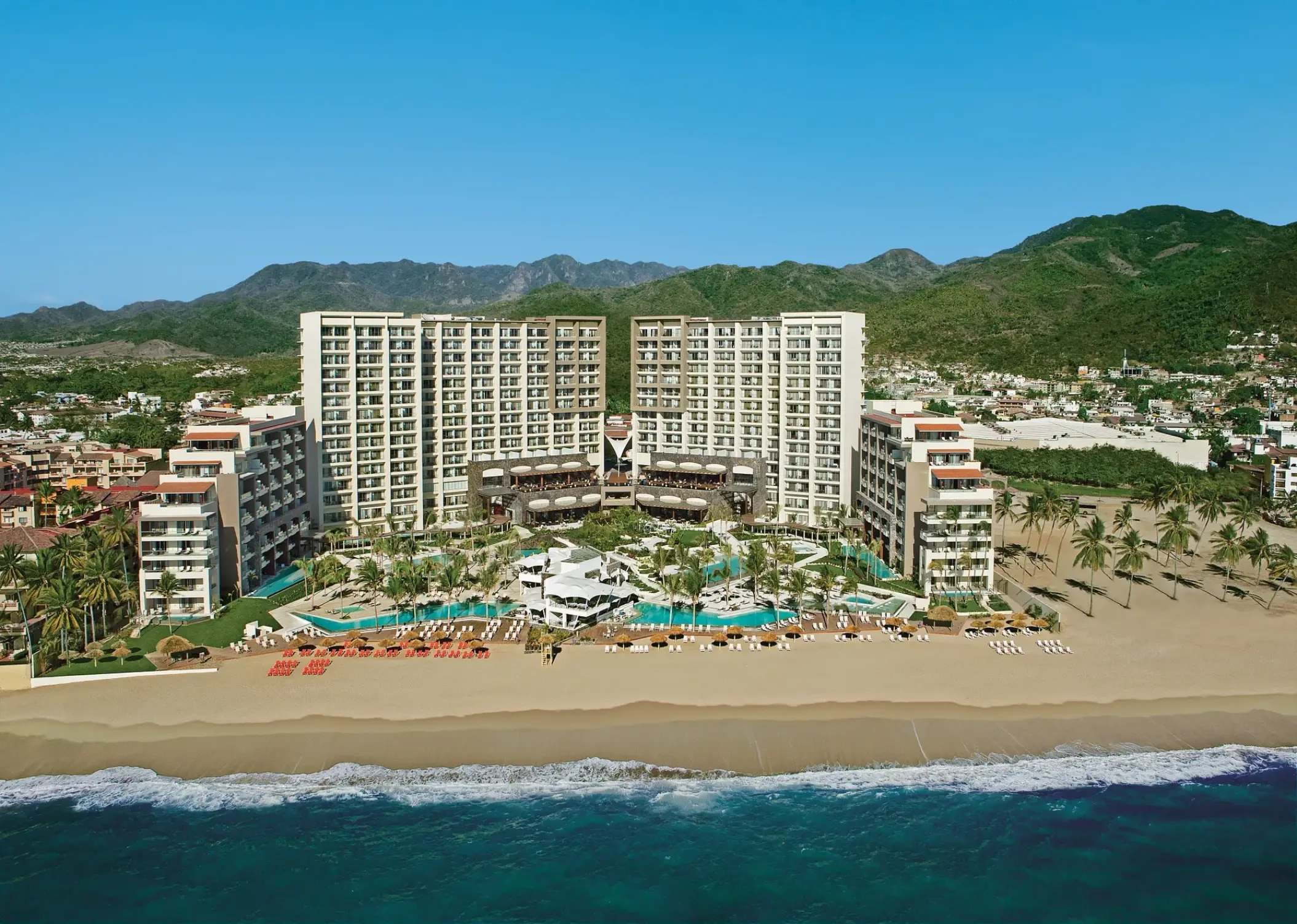 Aerial view of Secrets Vallarta Bay beachfront exterior and pools, Puerto Vallarta
