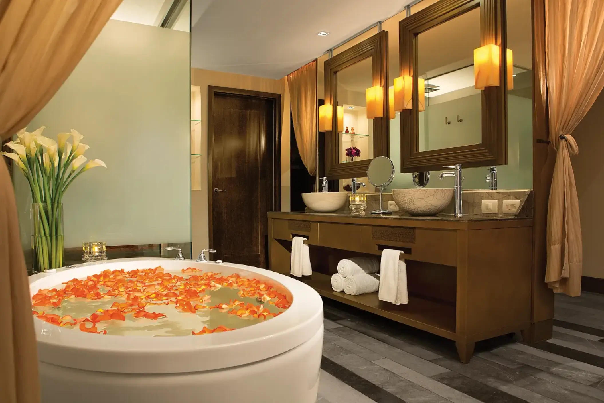 Master bathroom suite with orange flower petals in the soaking tub at Secrets Vallarta Bay, Puerto Vallarta