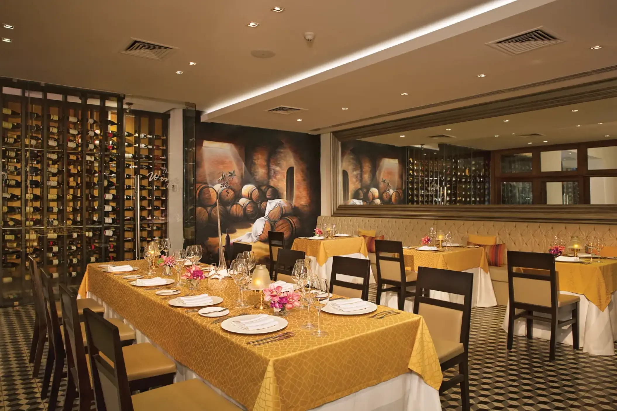 Portofino restaurant dining room with yellow linens and wine cellar at Secrets Vallarta Bay, Puerto Vallarta