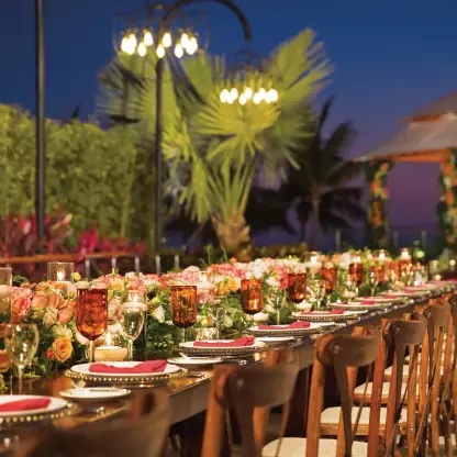 Terrace wedding reception with floral centerpieces and candles at Secrets Vallarta Bay, Puerto Vallarta