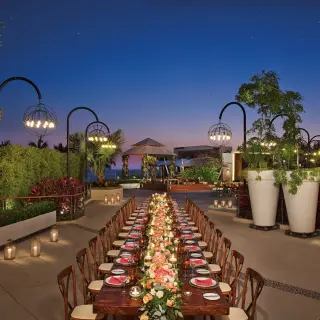 Outdoor wedding reception setup with a long table at night at Secrets Vallarta Bay, Puerto Vallarta