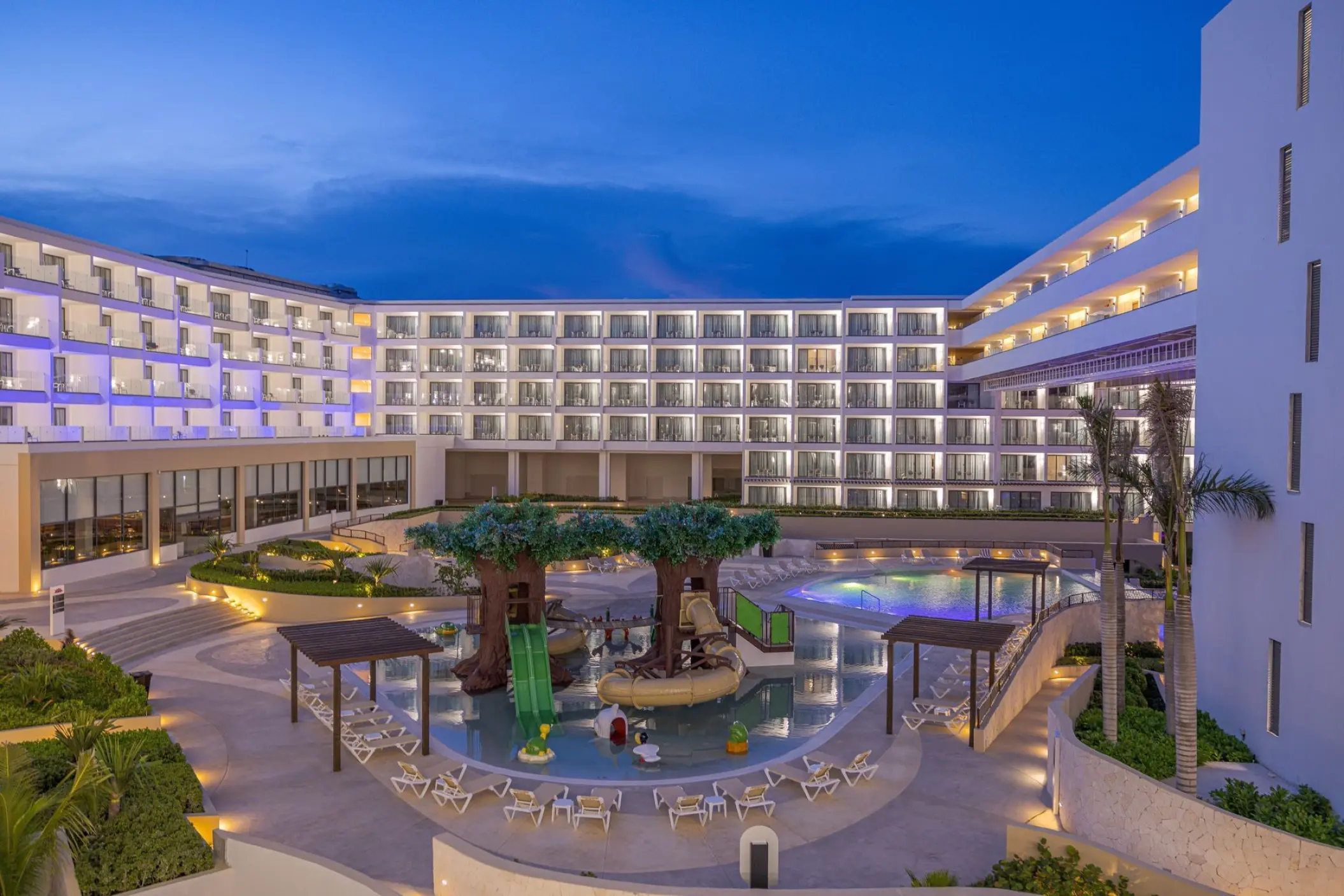 Family aquapark and pool at Sensira Riviera Maya at twilight