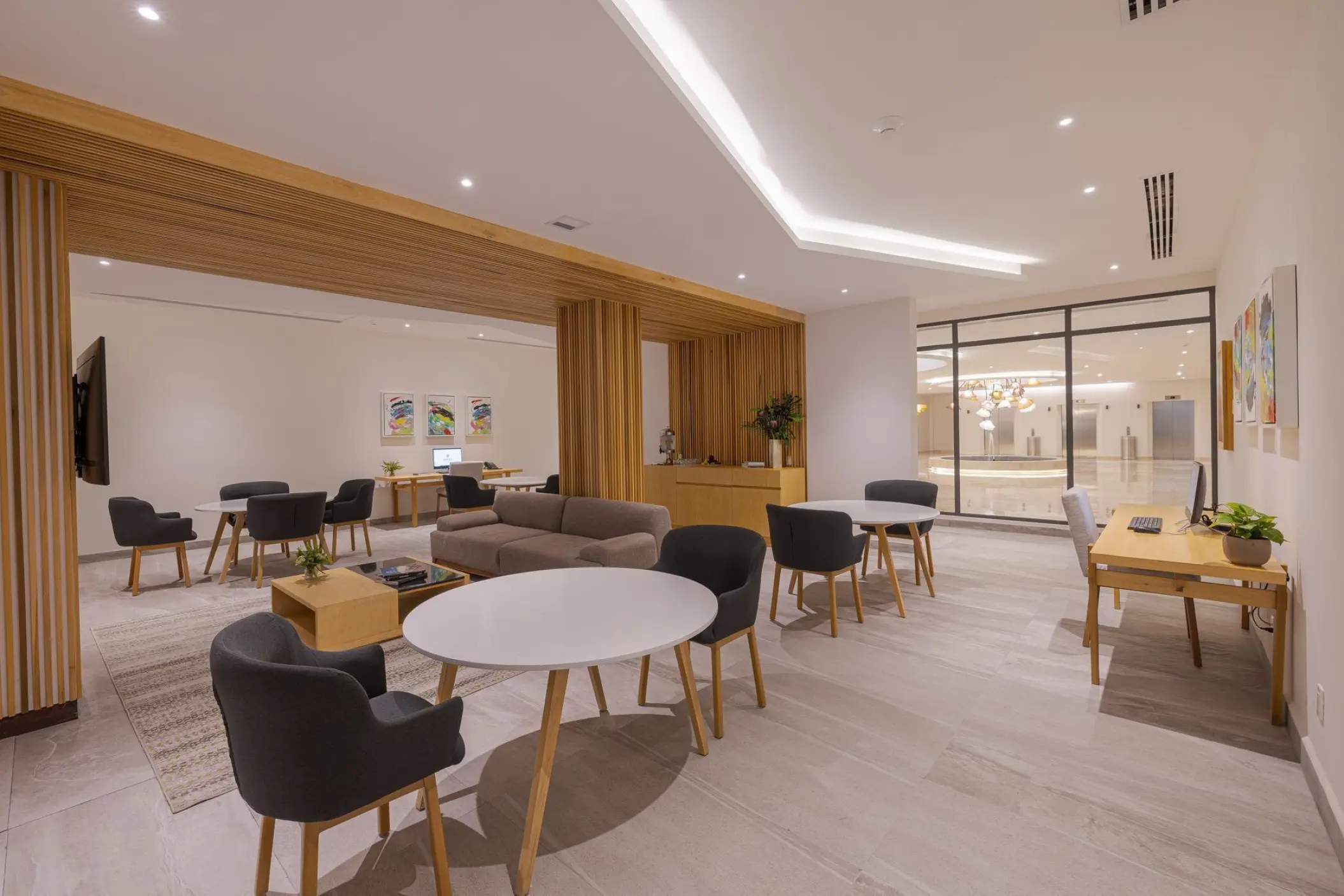 Connectivity room with desks, lounge seating, and tables at Sensira Resort, Riviera Maya