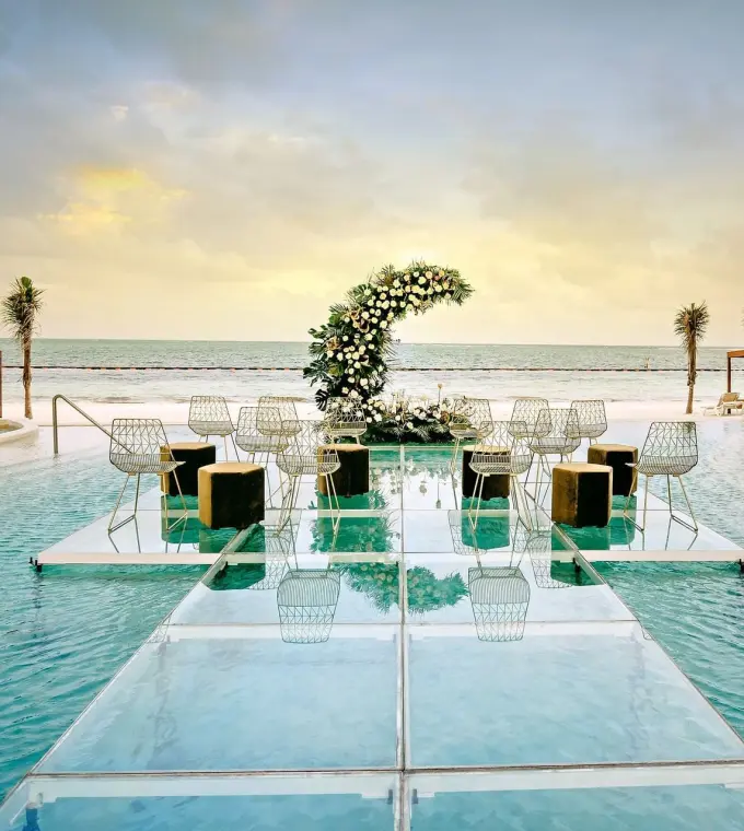 Acrylic aisle for a pool wedding ceremony at Sensira Riviera Maya