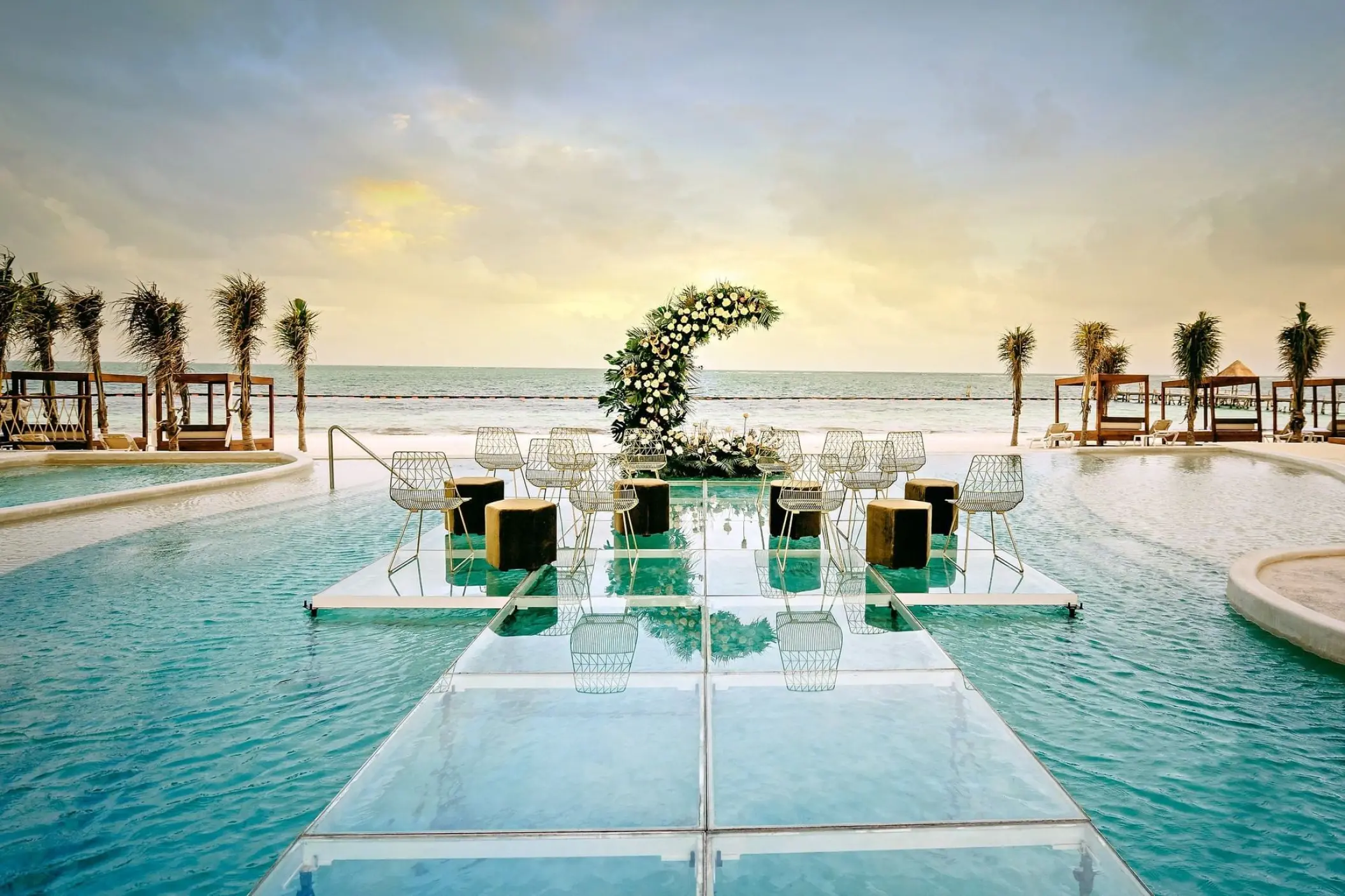 Acrylic aisle for a pool wedding ceremony at Sensira Riviera Maya