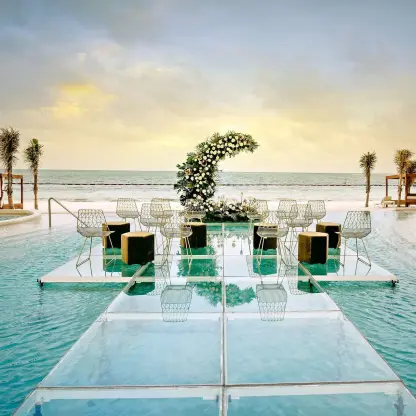 Glass platform wedding ceremony over the pool at Sensira Riviera Maya