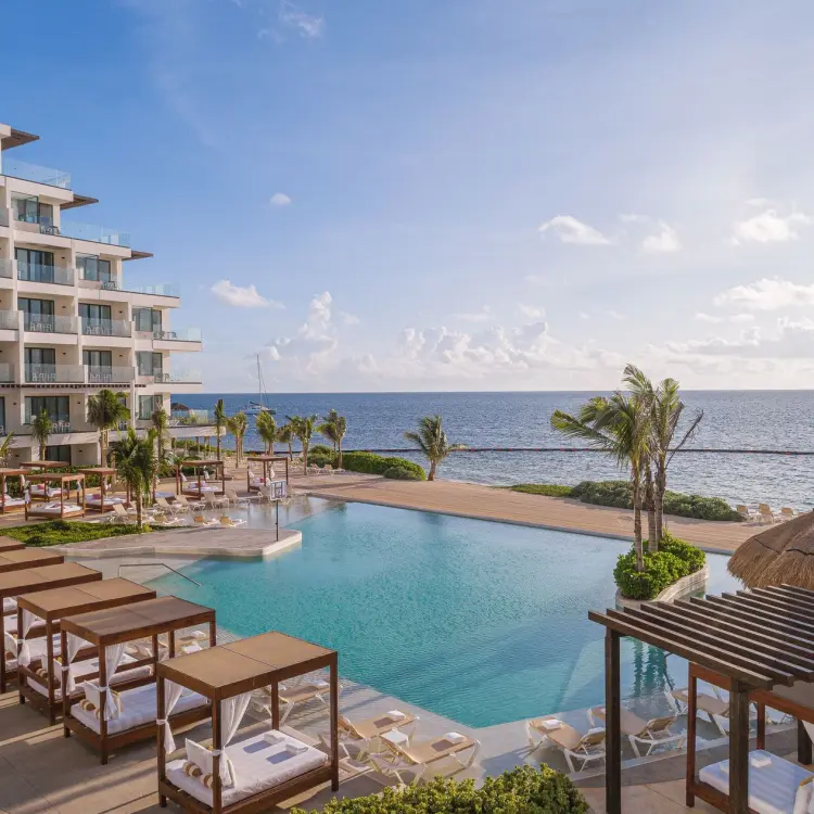 Sensira Riviera Maya infinity pool with ocean view and poolside cabanas, Riviera Maya
