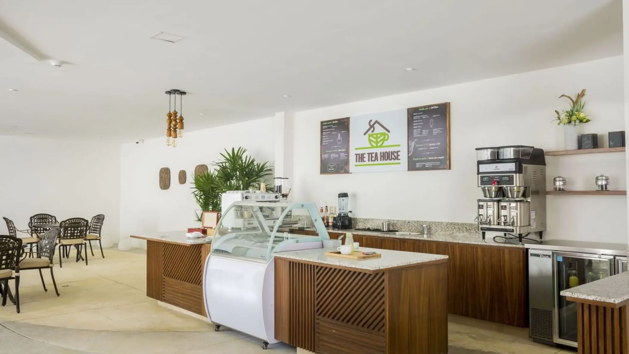 The Tea House cafe interior with wooden counters and coffee machines at Sensira Resort, Riviera Maya