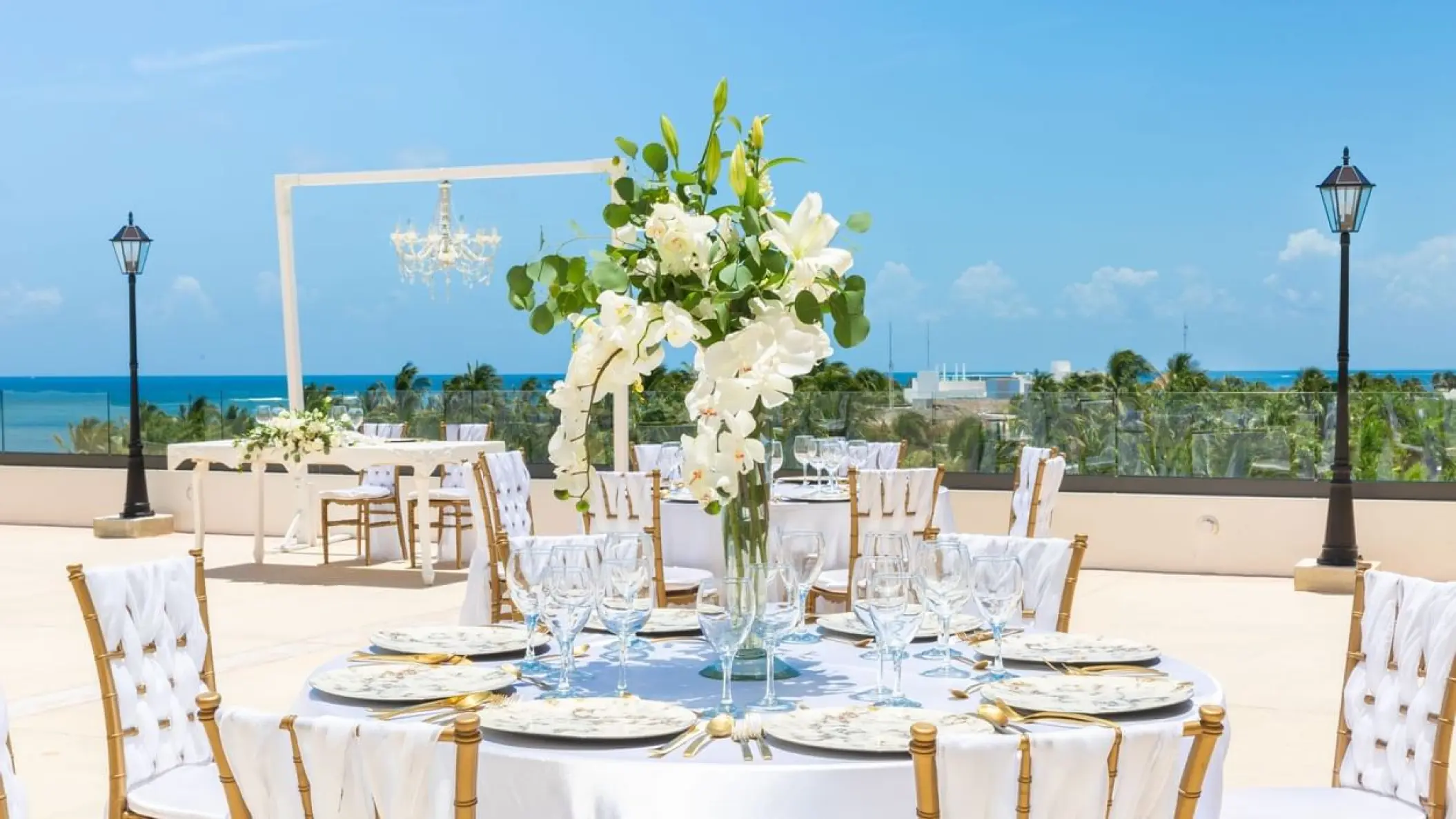 Rooftop wedding reception with white floral centerpieces at Sensira Riviera Maya
