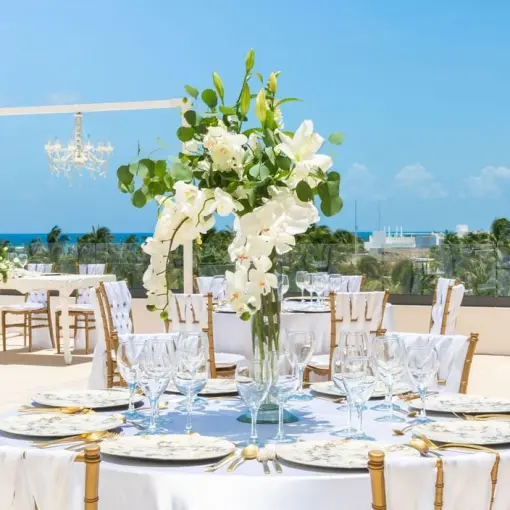 Rooftop wedding reception with white floral centerpieces at Sensira Riviera Maya