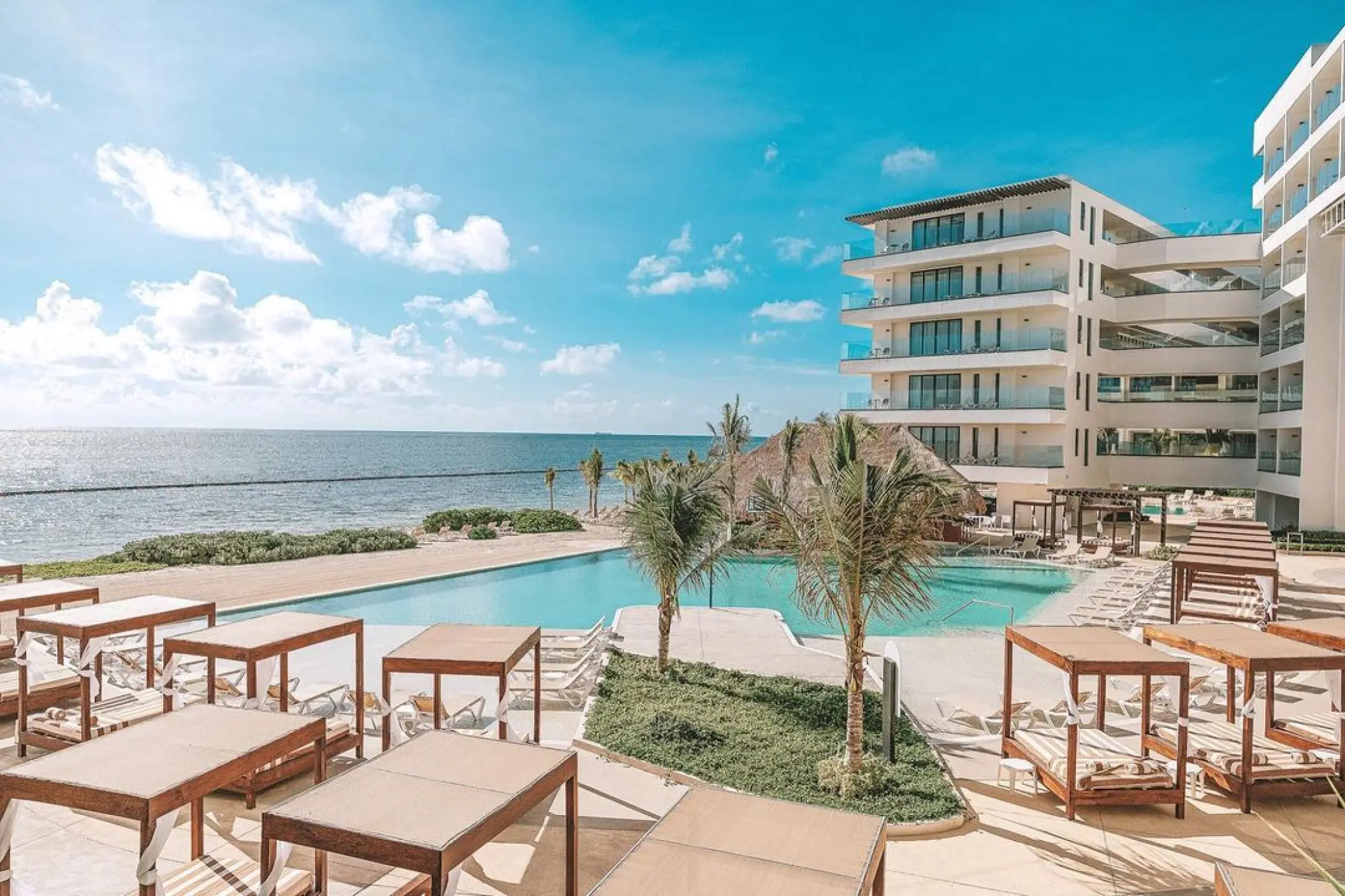 Sensira Riviera Maya beachfront pool area with daybeds and lounge chairs, Riviera Maya