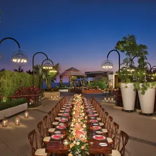 Terrace wedding reception with long tables and lanterns at Secrets Maroma Beach, Riviera Maya