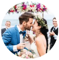 Bride and groom about to kiss during a beach wedding ceremony