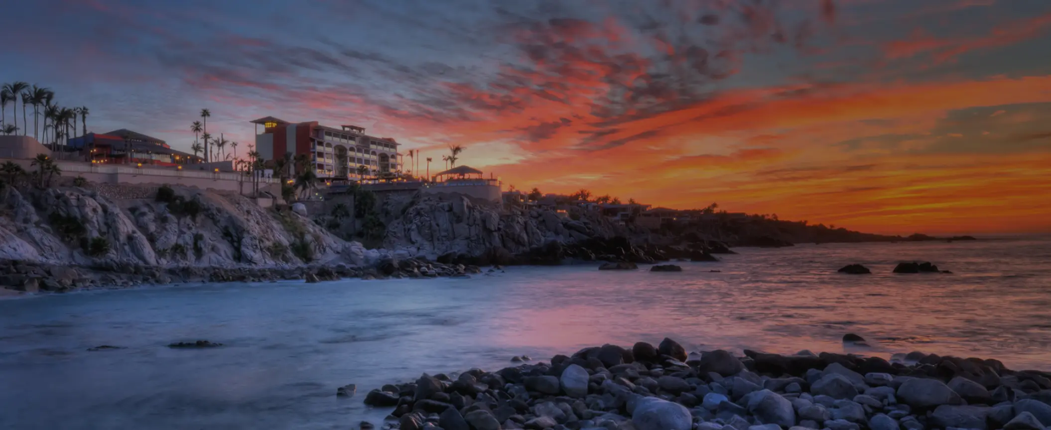 Hyatt Vacation Club at Sirena del Mar on a rocky clifftop at sunset, Cabo San Lucas