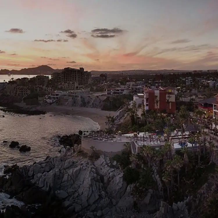 Aerial view of Hyatt Vacation Club at Sirena del Mar buildings on a rocky clifftop at sunset, Cabo San Lucas