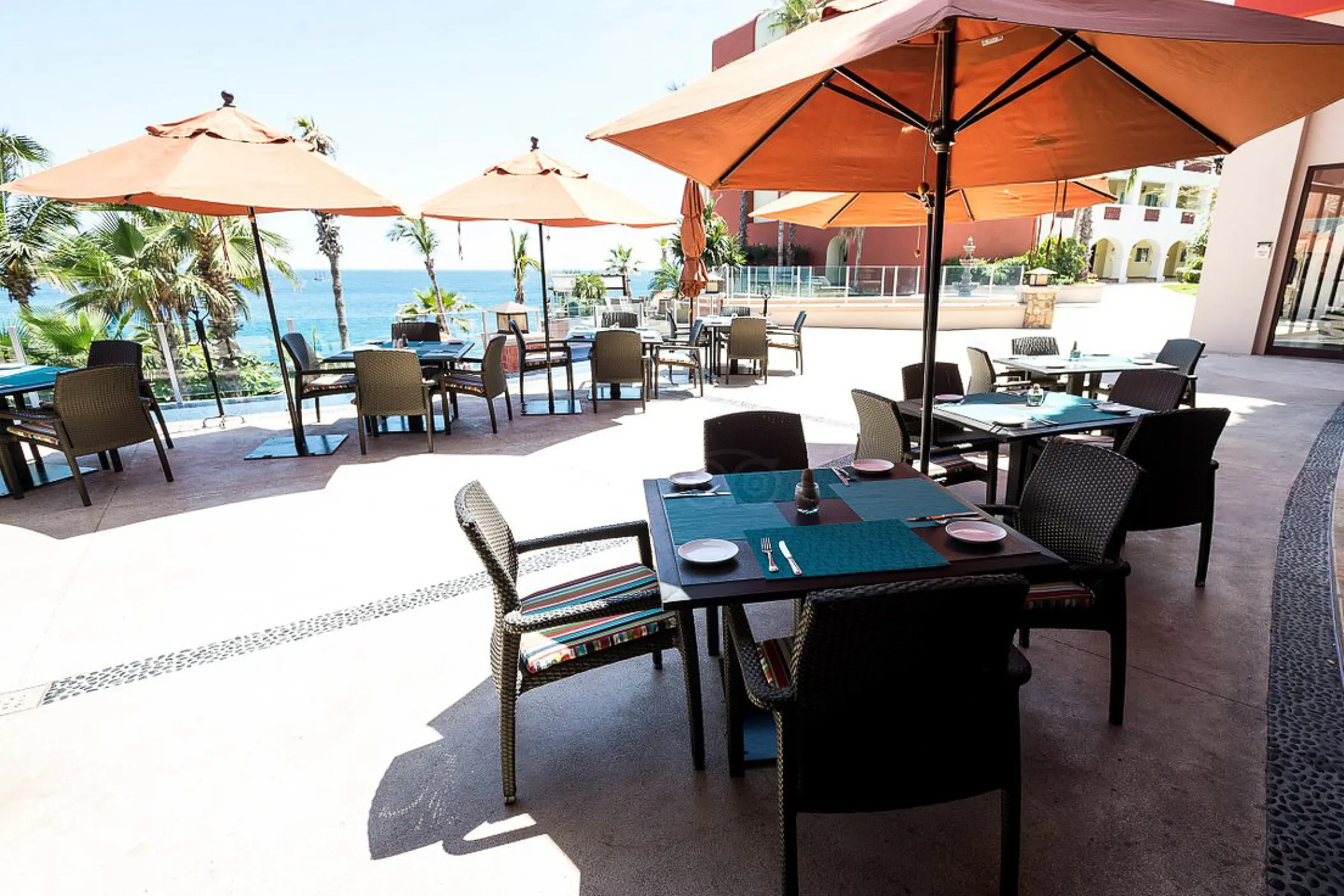 Outdoor restaurant terrace with orange umbrellas at Hyatt Vacation Club at Sirena del Mar, Cabo San Lucas