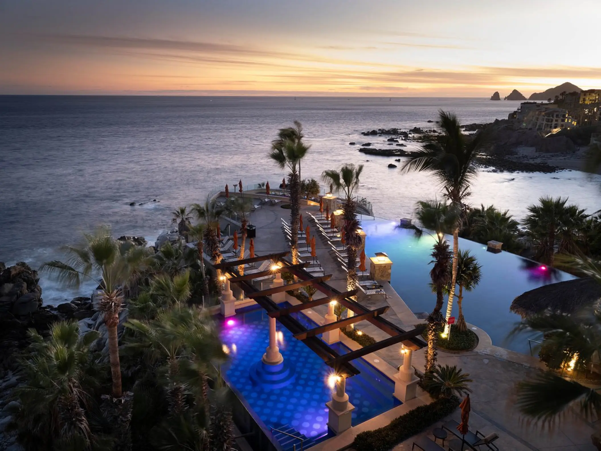 Dusk view of the infinity pool and clifftop terrace at Hyatt Vacation Club at Sirena del Mar, Cabo San Lucas
