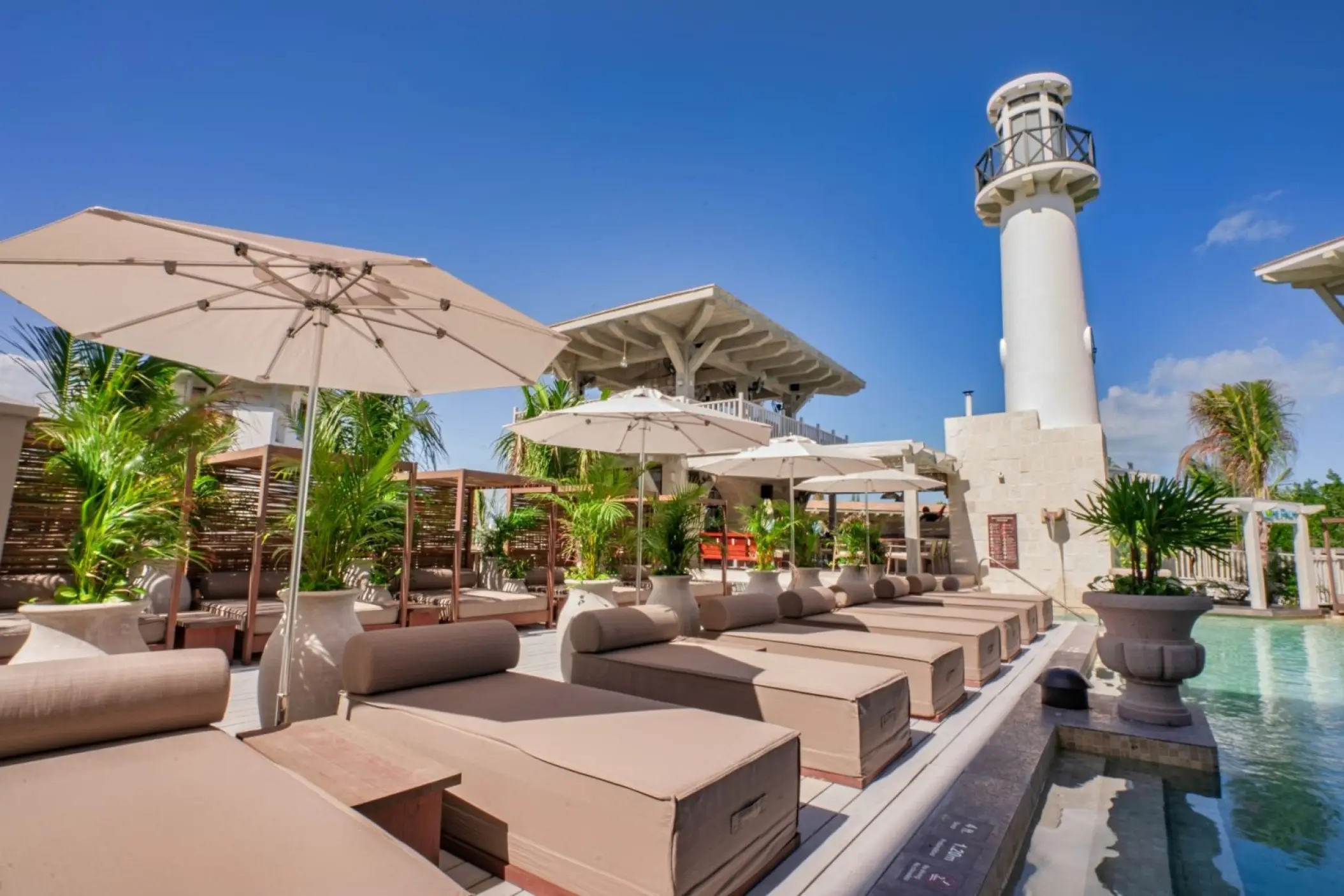 St. Somewhere Resort Holbox main pool and sun loungers by a decorative lighthouse, Isla Holbox