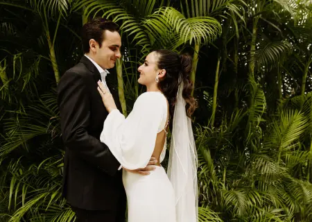 Alyssa & Ryan's portrait against lush palm trees at Dreams Natura, Riviera Maya