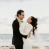 Alyssa & Ryan embracing during their beach wedding ceremony portrait