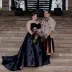 Ariel & Ian's wedding portrait on stone stairs, featuring a black gown and colorful kilt