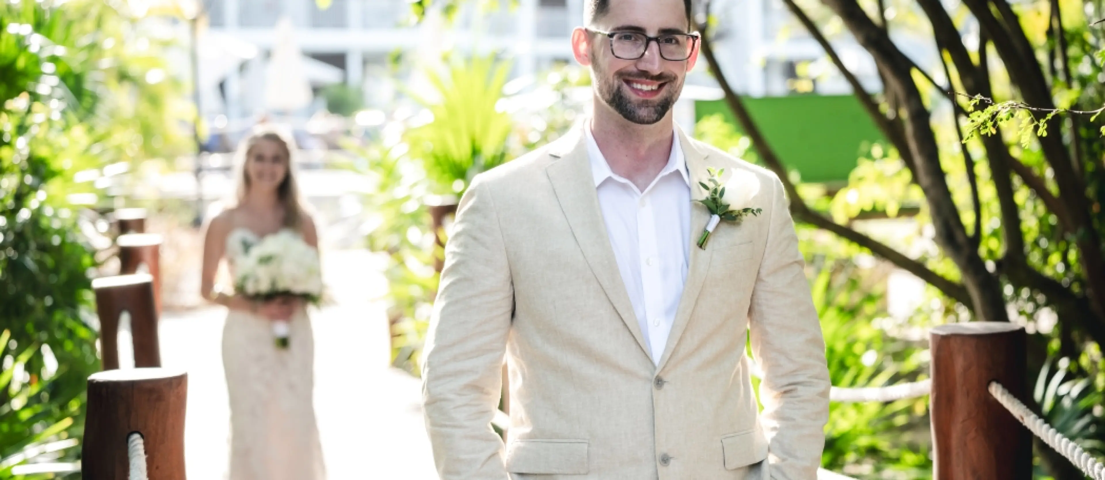 Danielle and Derrek’s first look wedding moment on a tropical walkway