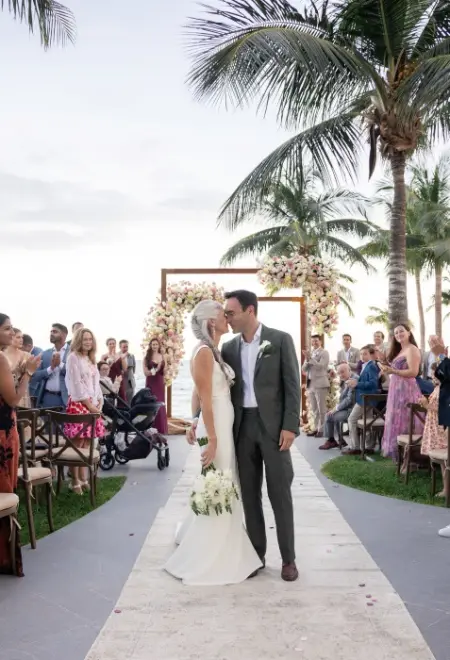 Lindsey & Jeff kissing at the aisle after their ceremony at Garza Blanca Cancun