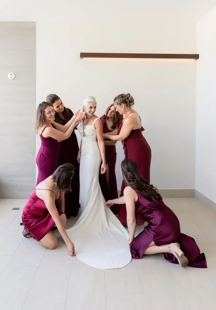 Lindsey getting ready with bridesmaids in maroon dresses at Garza Blanca Cancun