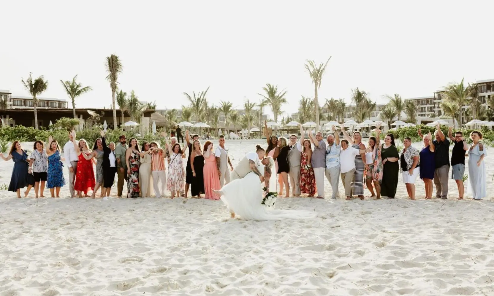 Jennifer & Chelsey kissing in front of their wedding guests at Secrets Playa Blanca, Cancun