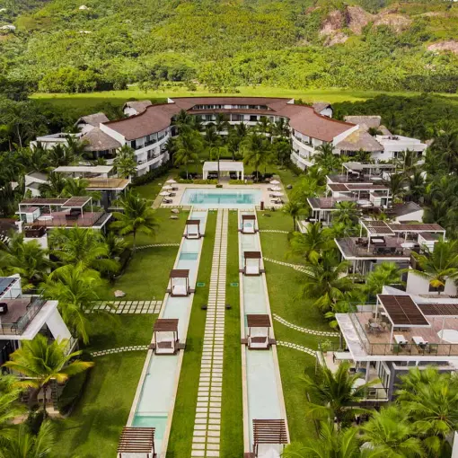 Aerial view of Sublime Samaná lawns, pools and villas surrounded by lush greenery, Samana