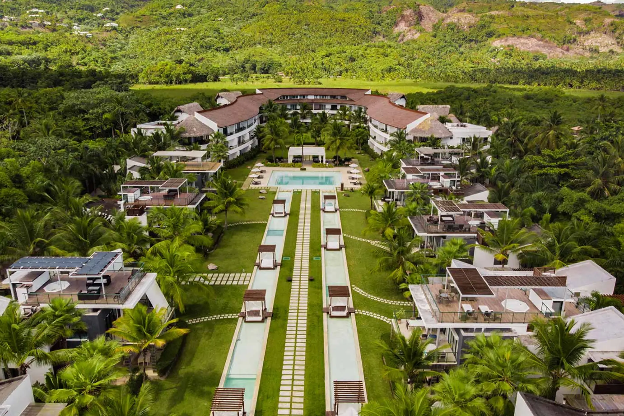 Aerial view of Sublime Samaná lawns, pools and villas surrounded by lush greenery, Samana