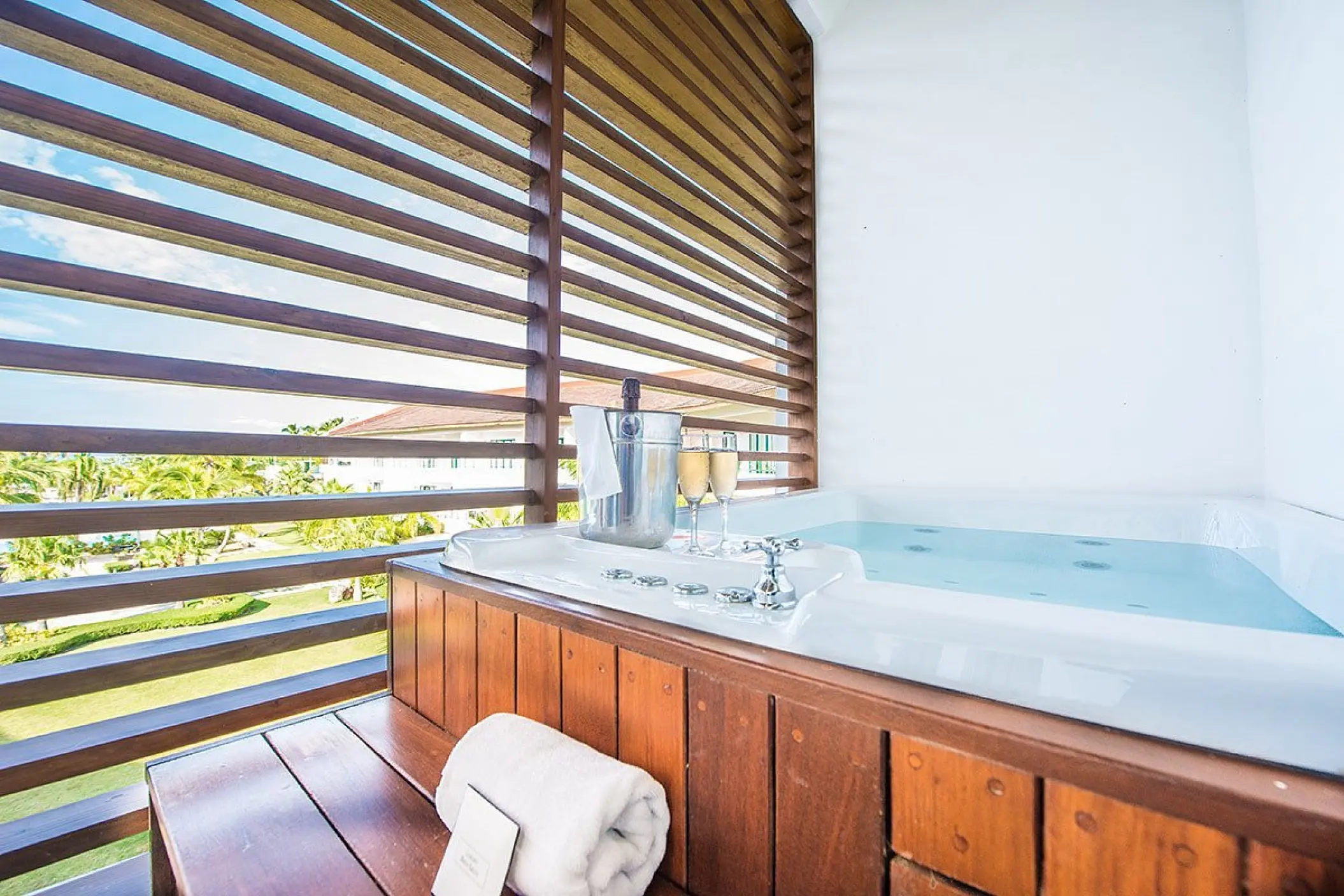 Private balcony whirlpool with champagne and garden views at Sublime Samana, Samana