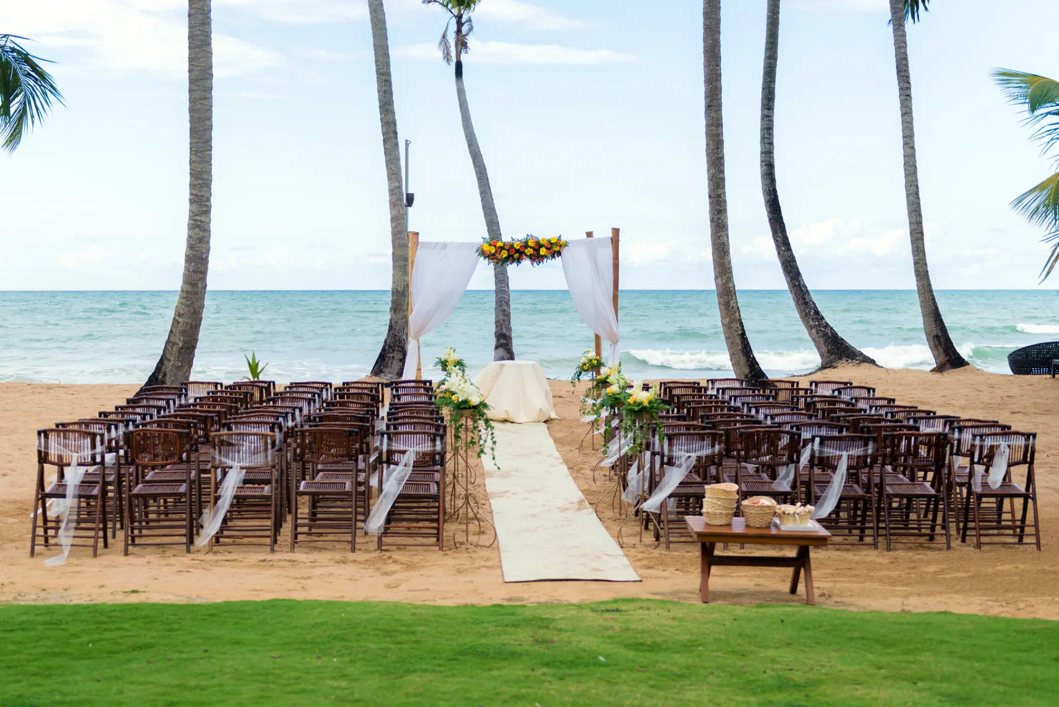 Beachfront wedding ceremony setup under palm trees at Sublime Samana, Samana