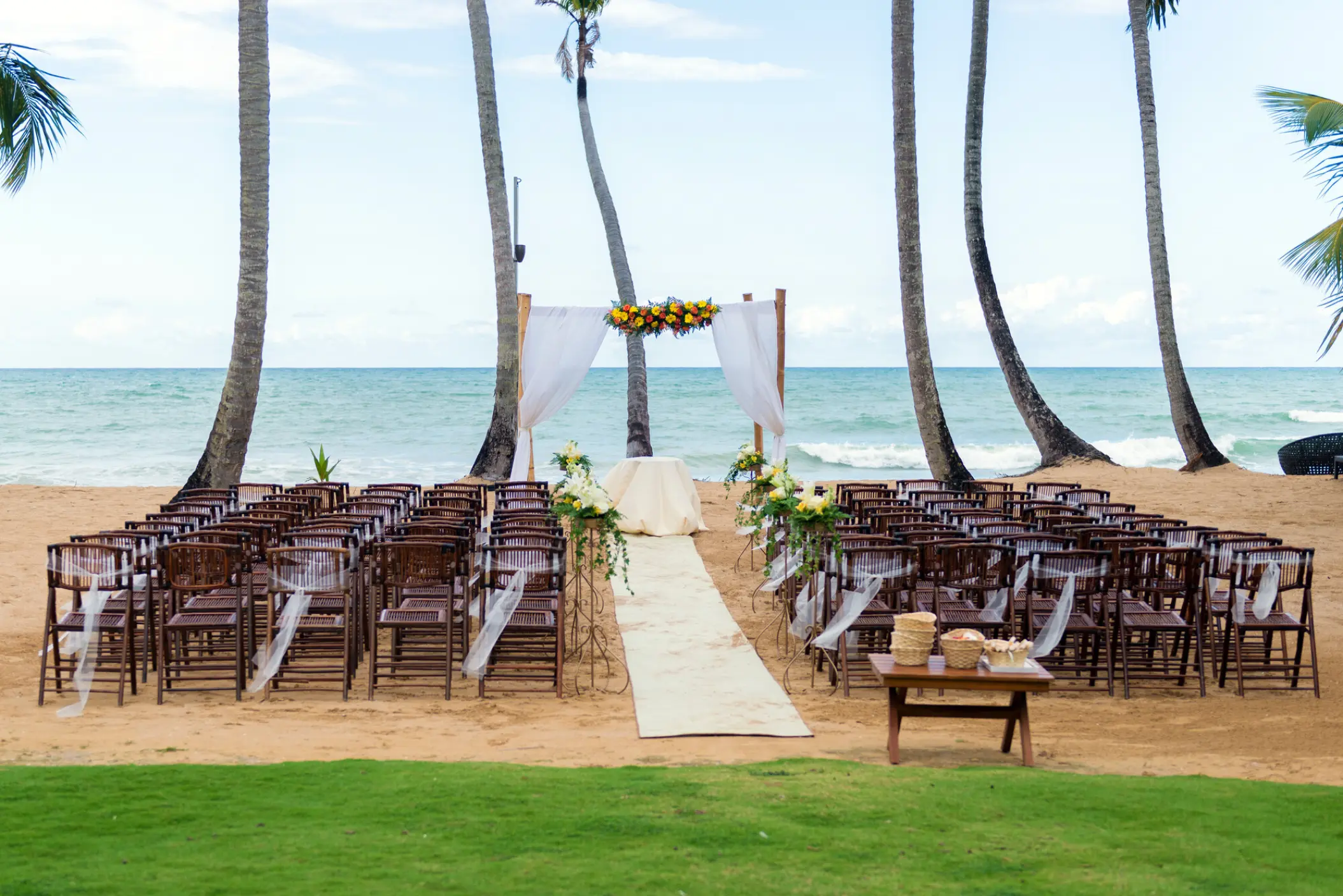 Beachfront wedding ceremony setup under palm trees at Sublime Samana, Samana