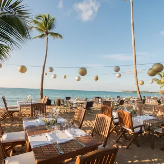 Beachfront wedding reception tables with paper lanterns at Sublime Samaná, Samana