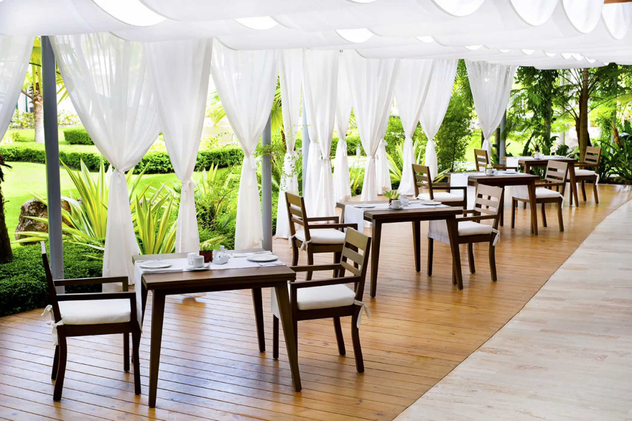 Bistro wedding reception tables under a white canopy at Sublime Samaná, Samana