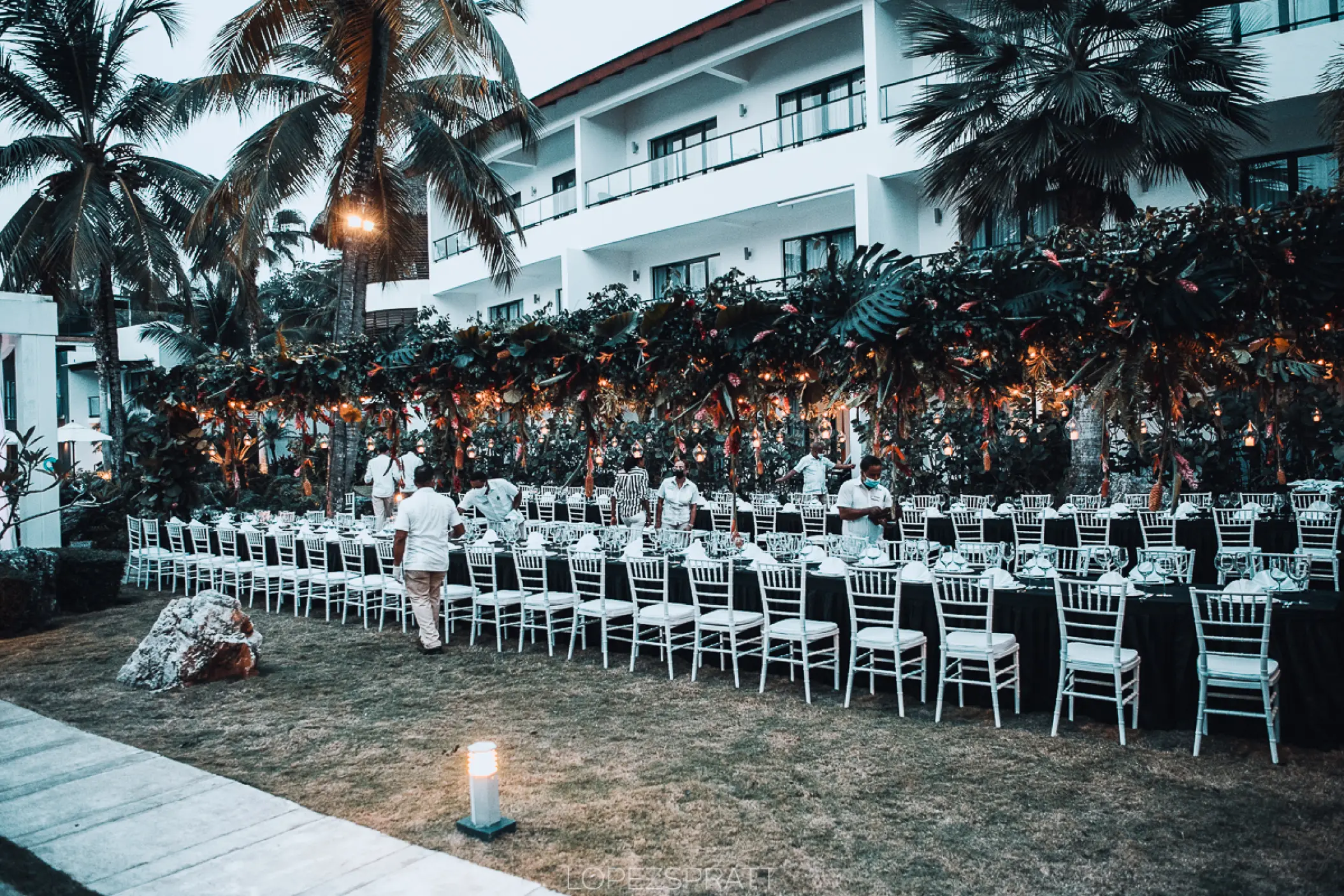 Garden wedding reception setup with long tables and white chairs at Sublime Samana, Samana