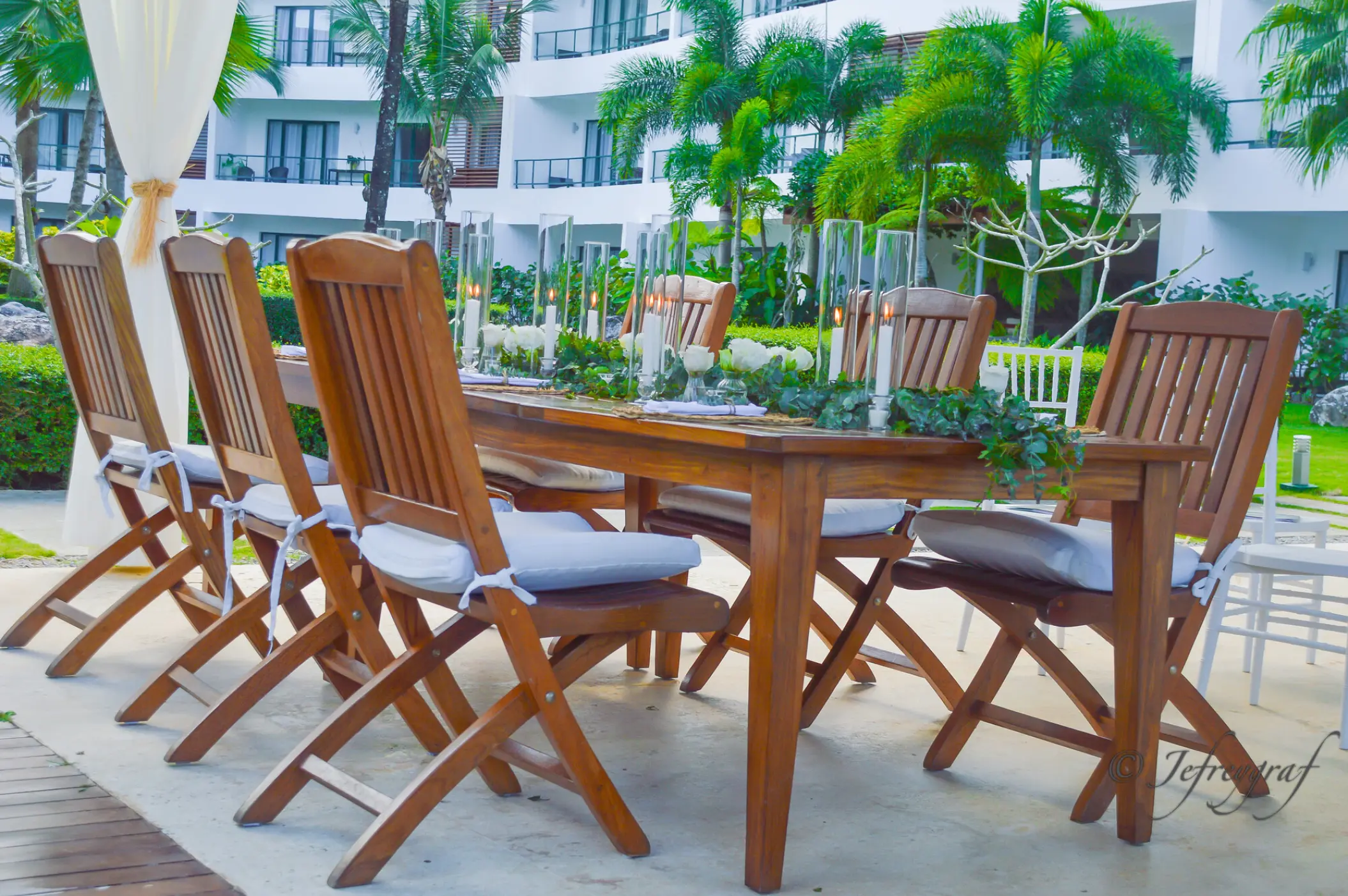 Outdoor wedding reception table with wooden chairs and greenery at Sublime Samaná, Samana