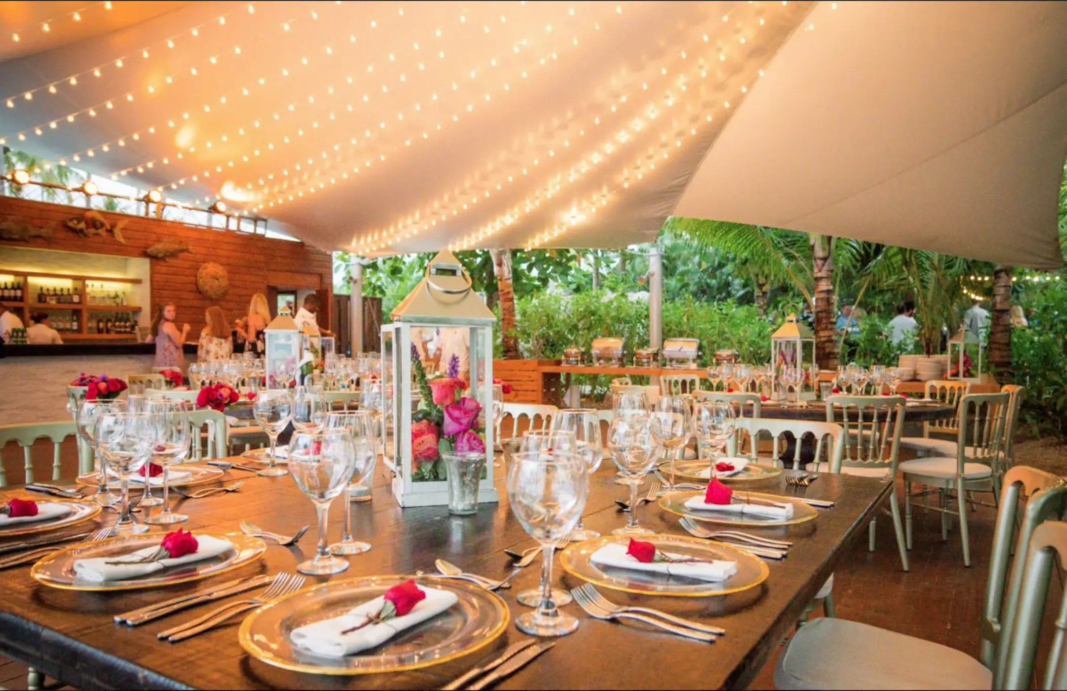 Wedding reception setup under a tent with string lights at Sublime Samaná, Samana