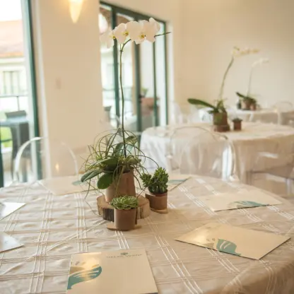 Wedding reception tables with white orchids and ghost chairs at Sublime Samaná, Samana